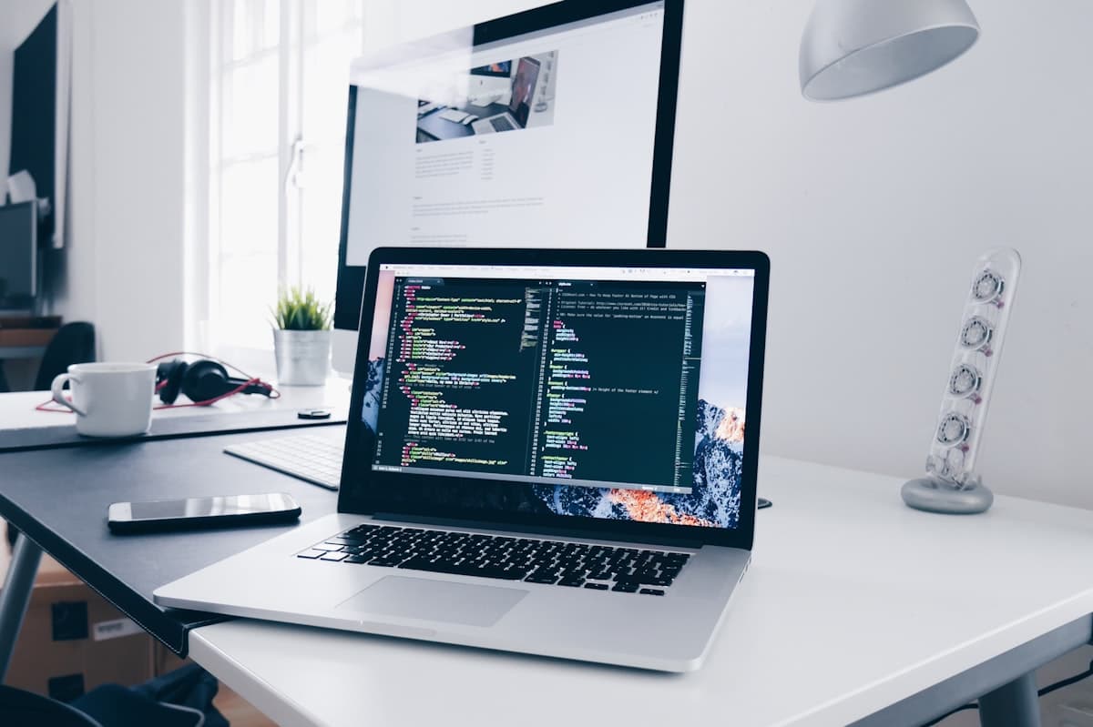 Developer working on laptop with code